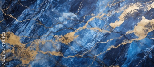 A detailed close up of a blue and gold marble, showcasing intricate patterns and textures. The blue and gold colors blend beautifully in this decorative marble slab.