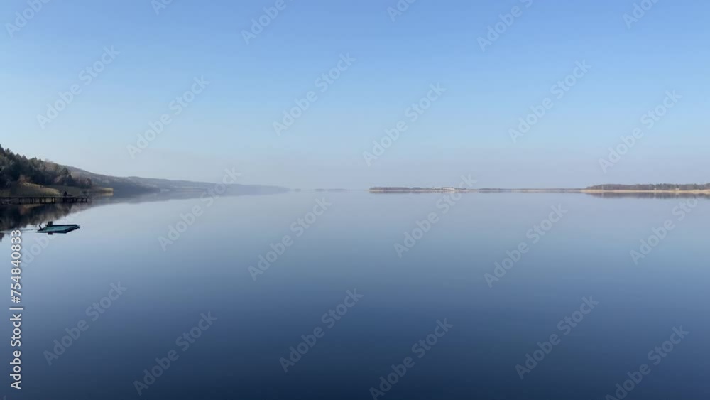 Calm water on the river. The wide reservoir of the Dnipro. Fresh water river. Windless morning on the lake. Blue sky and river. Reflection of clouds in water. Spring landscape. Navigable river. 4k Calm water on the river. The wide reservoir of the Dnipro. Fresh water river. Windless morning on the lake. Blue sky and river. Reflection of clouds in water. Spring landscape. Navigable river. 4k