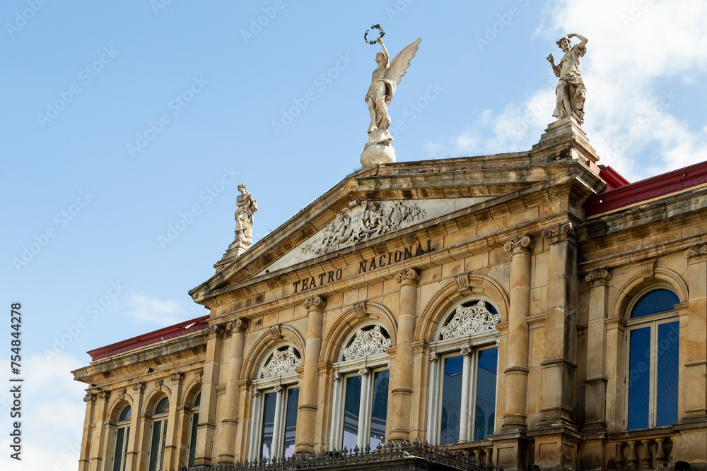 Low angle view of the 1897 National Theatre’s top story, with its magnificent neo-classical architecture and statues, San Jose, Costa Rica