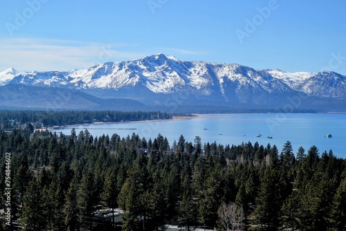 view of lake tahoe in front of the snowy mountain