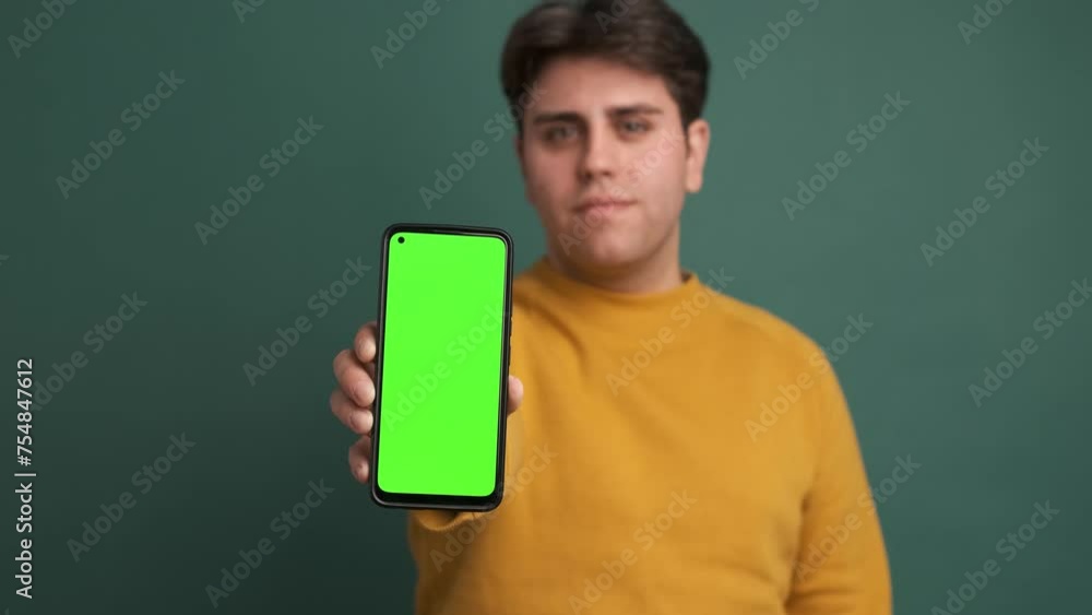 Man showing cell phone with green screen Man showing cell phone with green screen