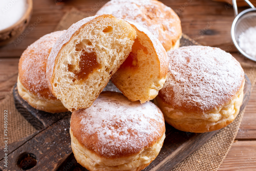 Home baked berliner donuts with apricot jam and sprinkled with sugar powder; delicious traditional Slovenian carnival food