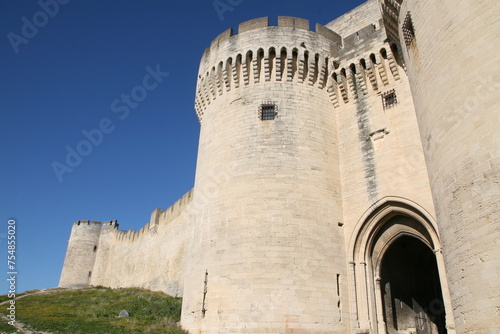 Fort Saint-André, a medieval defensive fortress located in Villeneuve-lès-Avignon, France. The white enclosure, with its crenellated towers, stands out against the blue sky.