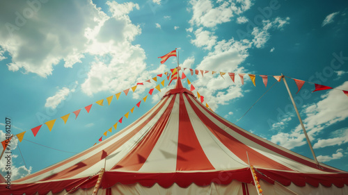 Striking circus tent under a vivid blue sky, adorned with fluttering flags in a festive celebration.