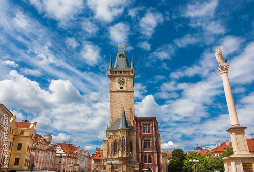 Old Town Hall medieval clock tower among clouds in Prague, a city landmark erected in 1364 in Old Town Square, with Marian Column photo