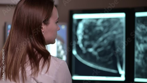 The doctor looks at the results of a computed tomography scan. The doctor examines the patient's MRI and looks for an oncological diagnosis