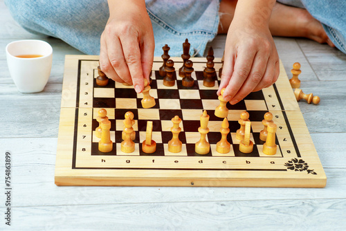 Obraz na plátně female hands placing pieces on a chessboard