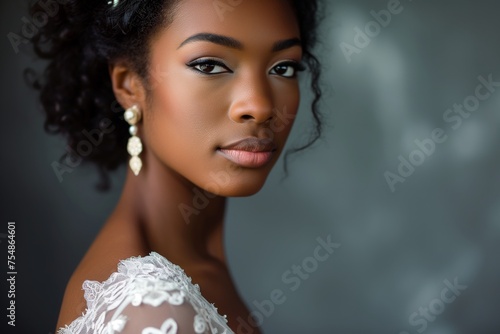 a close-up studio fashion portrait of a young african woman with perfect skin and immaculate make-up wearing white wedding dress and jewelry. Skin beauty and hormonal female health concept.