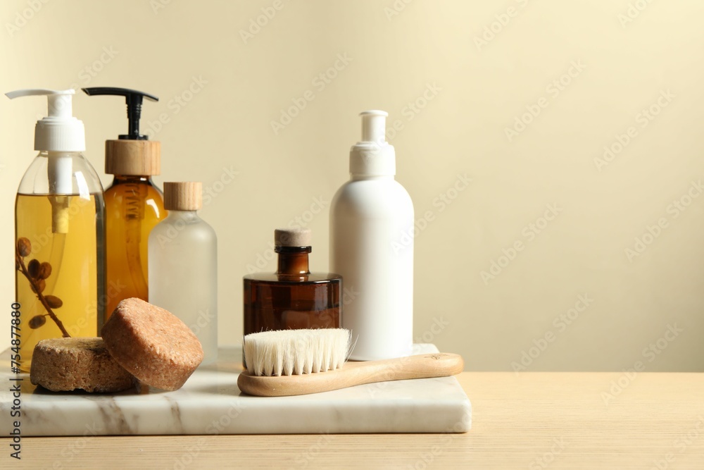 Different bath accessories on wooden table against beige background. Space for text Different bath accessories on wooden table against beige background. Space for text