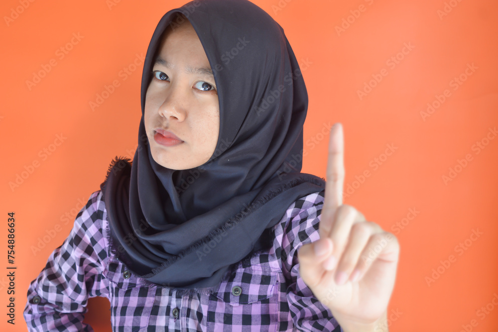 Portrait of Asian woman with black hijab showing a gesture of silence, don't say anything and be afraid. Asian Muslim woman Portrait of Asian woman with black hijab showing a gesture of silence, don't say anything and be afraid. Asian Muslim woman