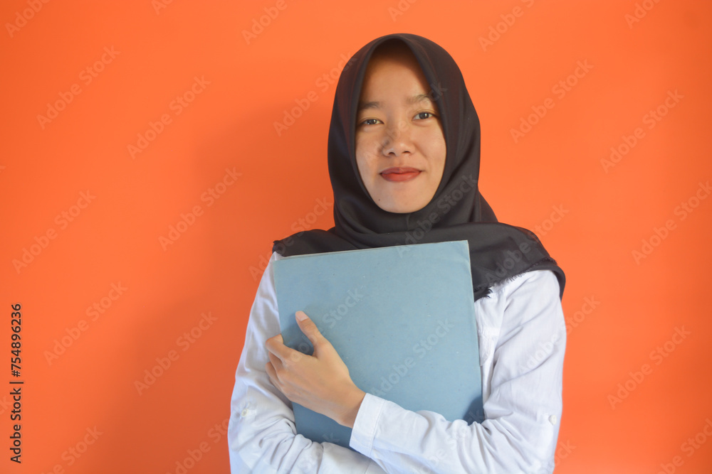 Close up of a young woman from Indonesia carrying a job application file Close up of a young woman from Indonesia carrying a job application file