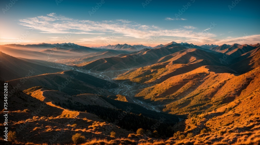 Sun setting over the mountains bathes the landscape in warm hues and shadows 