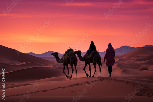 Spectacular desert sunset landscape with camels, sand dunes, and pink skies over the horizon at dusk