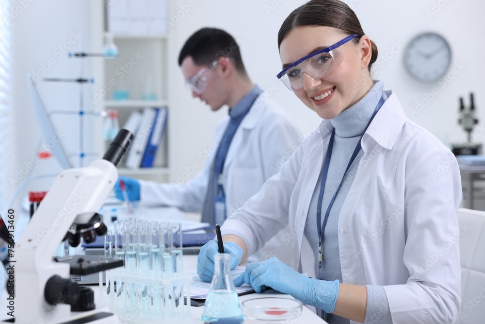 Scientists working with documents in laboratory. Medical research Scientists working with documents in laboratory. Medical research