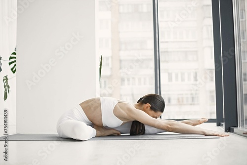 Young Fitness Woman Doing Yoga Stretching Mat Studio Wuth Big Windows 3