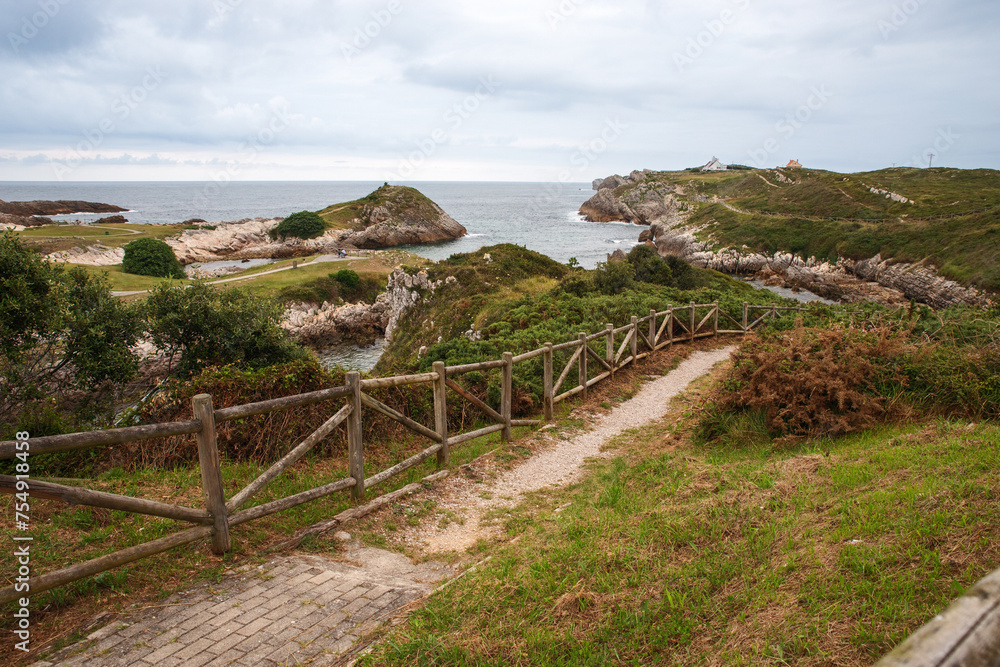 Serene coastal view with rocky outcroppings and lush vegetation. Serene coastal view with rocky outcroppings and lush vegetation.