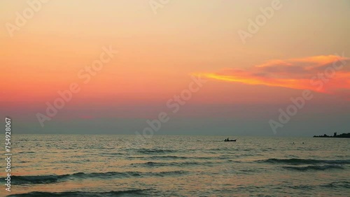 Moving boat near the beach under gloomy sky