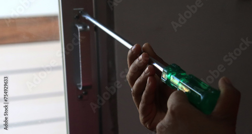 a woman screwing with a screwdriver