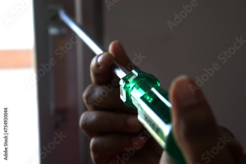a woman screwing with a screwdriver