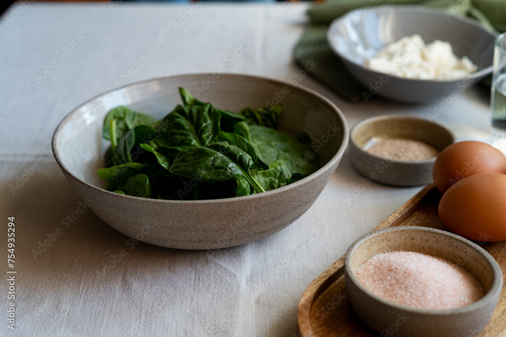 Spinach leaves in a plate. ingredients for healthy and delicious food Spinach leaves in a plate. ingredients for healthy and delicious food