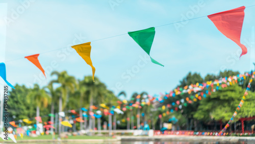 Summer fair flag bunting colorful background hanging on blue sky for fun fiesta party event, summer holiday farm feast celebration, carnival festival event, park or street festa design decoration © Chinnapong