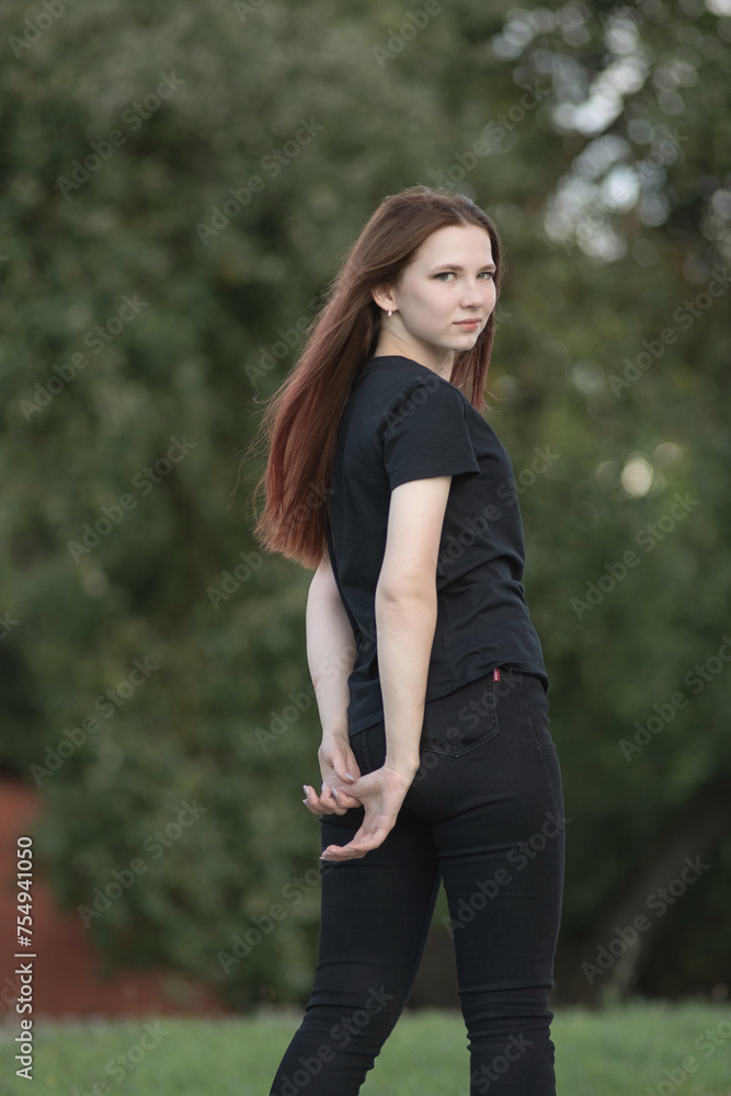Portrait of a young beautiful red-haired girl in an urban environment. Portrait of a young beautiful red-haired girl in an urban environment.