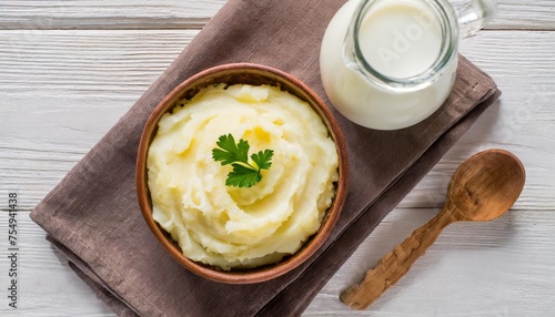 mashed potatoes in the bowl on the white wooden table with bottle of milk top view