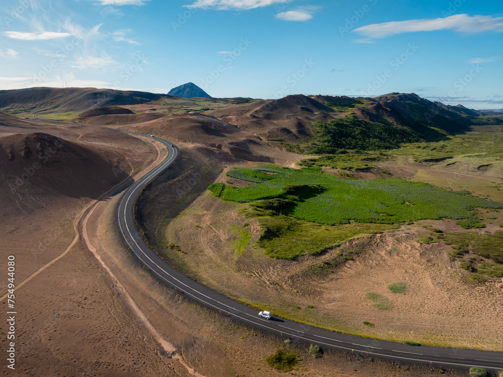 Panorama view of Ring Road in Iceland and scenic landscape of volcano rock formations on a bright summer day, aerial shot. Travel destination concept.