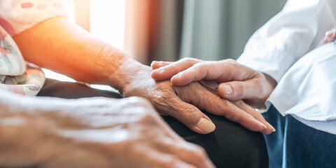 Parkinson disease patient, Alzheimer elderly senior, Arthritis person's hand in support of geriatric doctor or nursing caregiver, for disability awareness day, ageing society care service