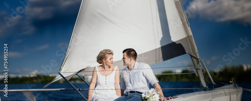 newlywed couple in love on a yacht at sea in the summer. © velimir