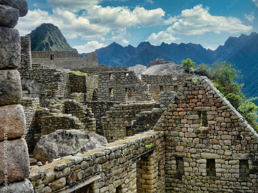 Overview of the characteristic stone houses in the famous 15th century archaeological site of Machu Picchu located in the Andes of Peru, designated a UNESCO World Heritage Site in 1983