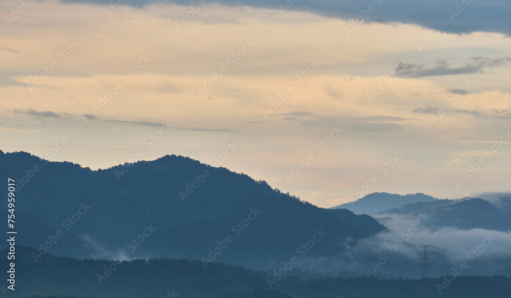 View of the hills in the afternoon after the rain is filled with mist