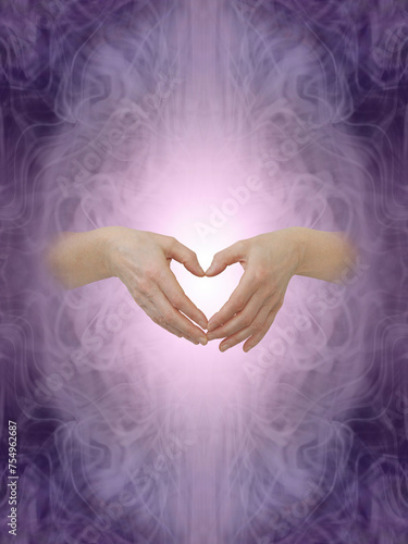 Love and blessings message background - Wispy purple ethereal symmetrical pattern background with female hands emerging making a heart shape with fingers and copy space above and below
