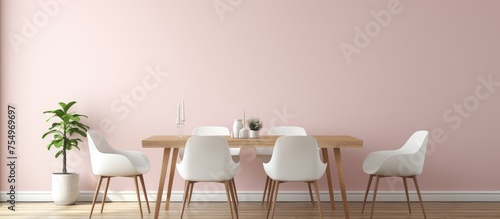 A dining room with pink walls and a wooden floor featuring white chairs arranged around a coffee table. A horizontal black poster hangs on the wall providing a touch of contrast.