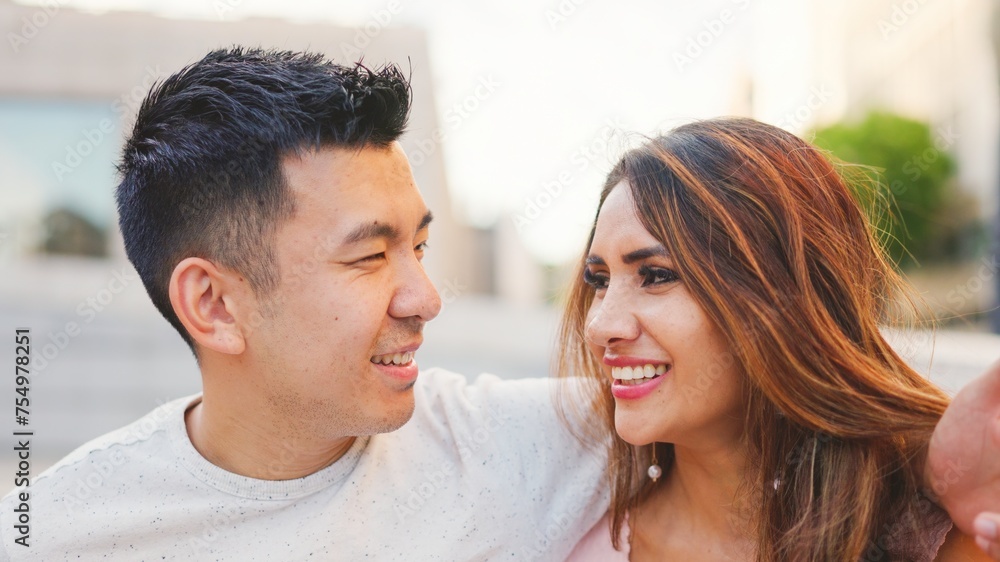 Multiethnic couple on the street looking at each other Multiethnic couple on the street looking at each other