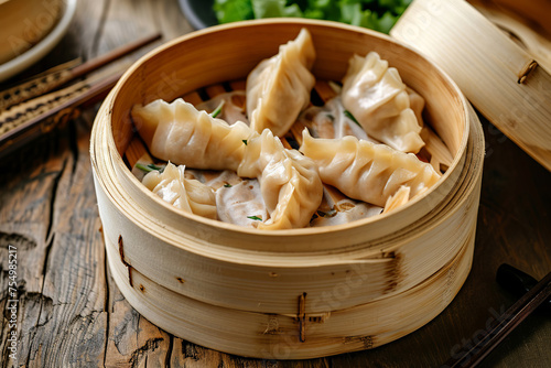 Piping hot delicious bamboo steamer of soup dumplings. Tasty baozi dumplings in bamboo steamer on white background. Chinese dumpling in a bamboo steamer box