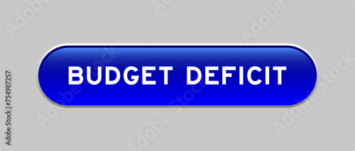 Blue color capsule shape button with word budget deficit on gray background