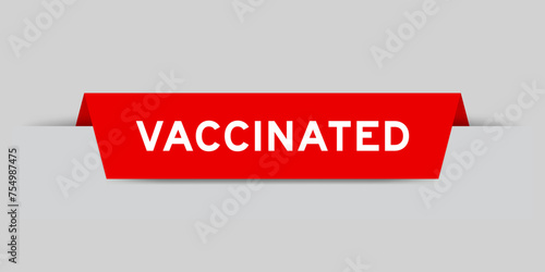 Red color inserted label with word vaccinated on gray background
