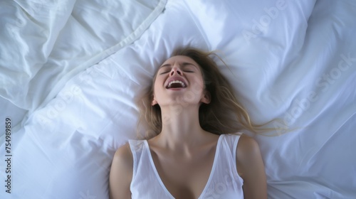 Woman's face during an orgasm in bed. Women's pleasure. A beautiful female with soft skin is enjoying and feels good.