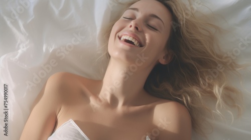 Woman's face during an orgasm in bed. Women's pleasure. A beautiful female with soft skin is enjoying and feels good.
