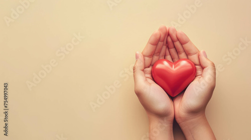 Conceptual image: hands of a woman cradle red heart on chic beige background. AI generative.