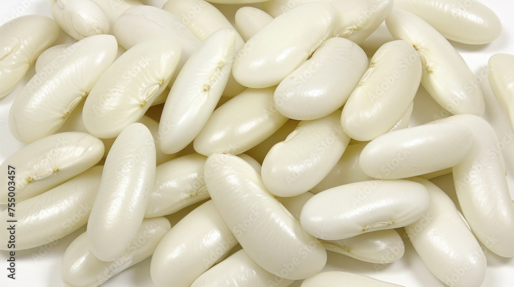 a pile of white beans sitting next to each other on a white surface with lots of white stuff on top of it. a pile of white beans sitting next to each other on a white surface with lots of white stuff on top of it.