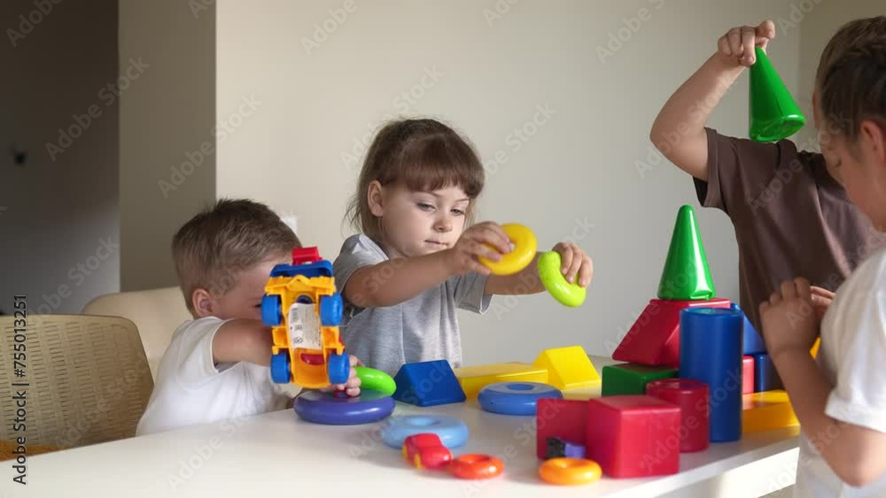 kindergarten. a group of children play toys cubes and cars on the table in indoor kindergarten. kid dream creative happy family preschool education concept. nursery baby toddler home kindergarten. a group of children play toys cubes and cars on the table in indoor kindergarten. kid dream creative happy family preschool education concept. nursery baby toddler home