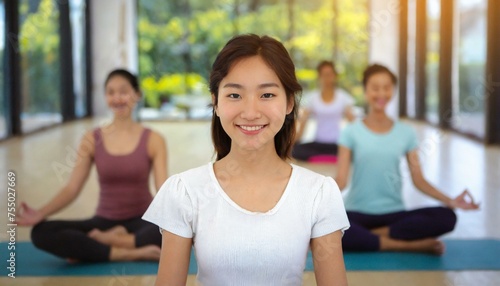 Smiling Mature woman meditating sitting in a yoga studio