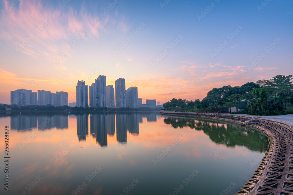 Fototapeta premium Buildings with reflections on lake at sunset at An Binh City, Hanoi.