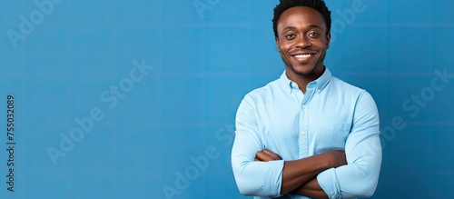 Confident Young Man Standing with Crossed Arms Showing Determination and Assertiveness photo