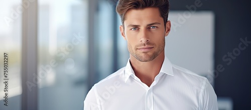 Confident male portrait with eye-catching expression, showing self-assurance in a sharp white shirt photo