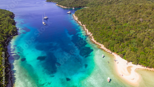 Sivota - stunning aerial drone video of turquoise sea known as Blue Lagoon and unique beach Bella Vraka. Epirus, Greece
