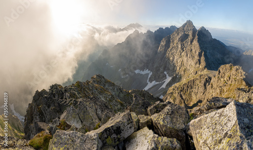 Panoramic view from Slovakia High Tatras Mountain peak Rysy in the foggy summer moring.