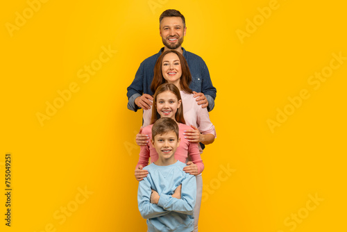 Happy Family, Mother, Father, Daughter And Son Embracing While Standing In Line © Prostock-studio